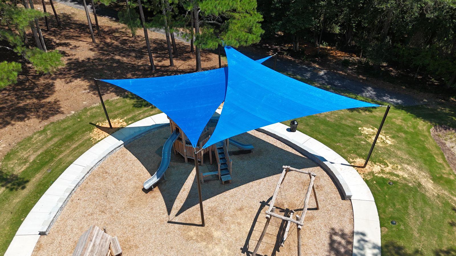 Aerial view of triangular shade sails over a park playground