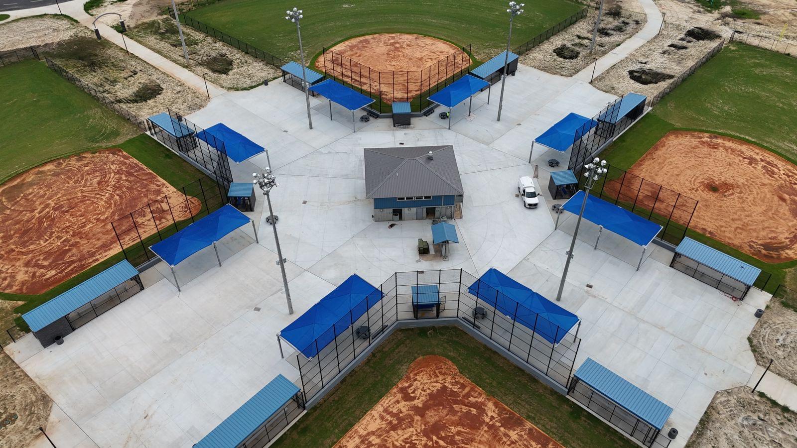 Bleacher Port canopies over dugouts and seating at a sports complex